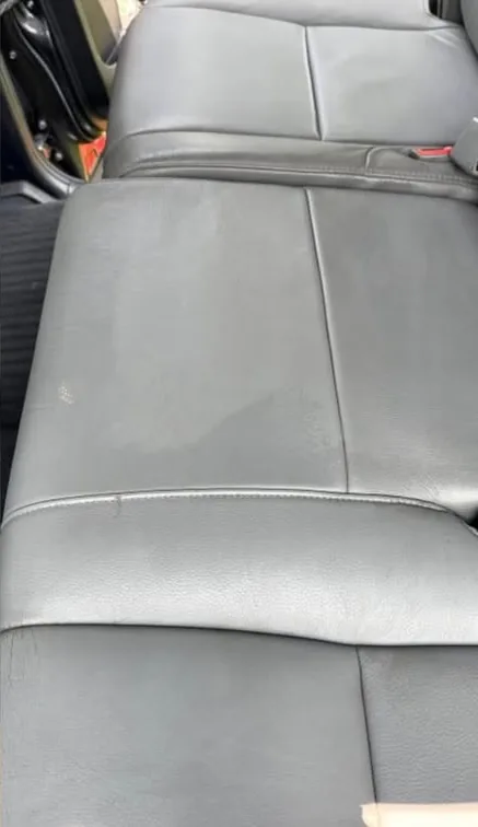 The same dark leather rear bench after cleaning and conditioning