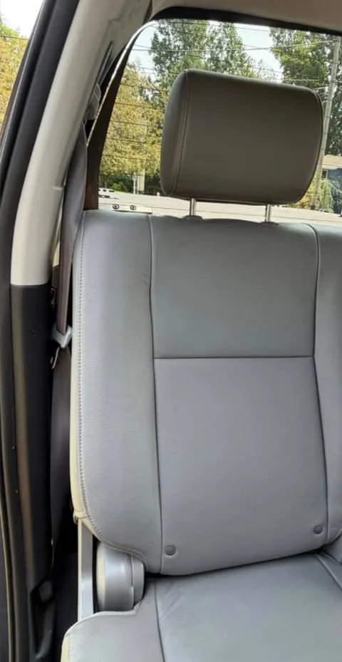 The same grey leather rear seat after cleaning, with the staining gone