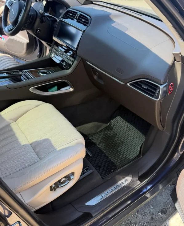 A Jaguar interior with cream leather seats after detailing